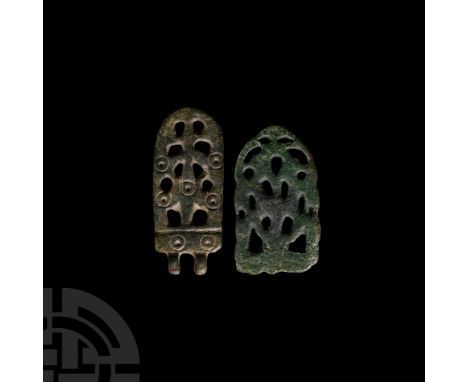 9th-11th century A.D. One bifacial tongue-shaped strap end with openwork scheme and punched ring-and-dot motifs; one composed