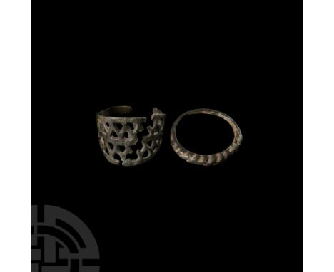 20th century A.D. or earlier. Comprising: one complete ring with faux-twisted bezel; one fragmentary ring bezel with openwork