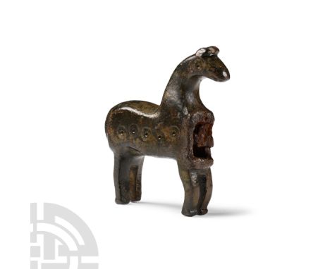 10th-12th century A.D. Formed as a standing horse with arched neck, ring-and-dot eyes, curved legs, D-shaped tail; cavity to 