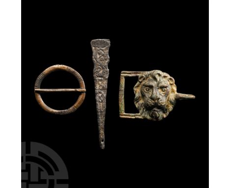 9th-18th century A.D. Comprising: bronze ring-brooch; bronze belt-fastener with lion-mask; strap end with Trewhiddle Style or