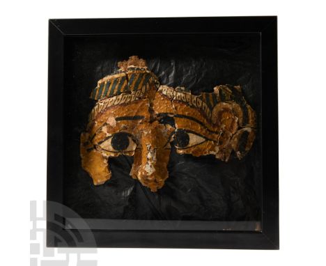 Ptolemaic-Roman Period, 332 B.C.-100 A.D. Mask fragment from a mummy with moulded and painted facial detailing; heavy black o