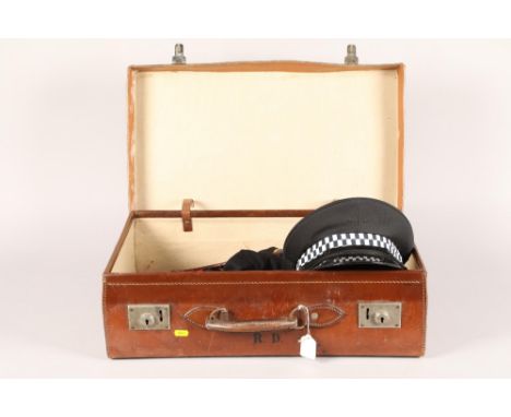 Leather suitcase; together with various police accessories including hat, handcuffs, whip and whistle 
