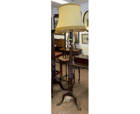 Carved mahogany floor standing standard lamp; raised on tripod supports 
