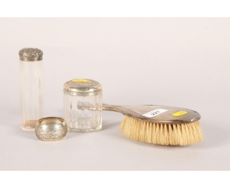 Two silver topped dressing table jars; solver backed mirror and a napkin ring 