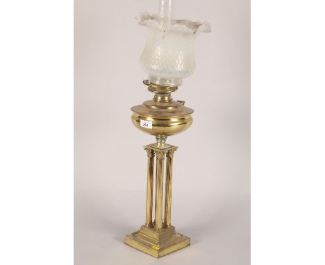Regency style brass oil lamp; with four reeded columns; raised on stepped square base and cloudy glass shadeCONDITION REPORT: