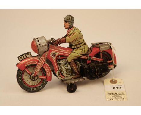 A rare Arnold A643 tinplate clockwork touring motorcycle. In red and white with litho detailing, rider in yellow/brown overal
