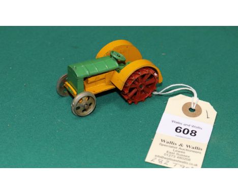 A Dinky Toys Farm Tractor. In green and yellow with cast-in hook. Unpainted base and front wheels. VGC, minor marks for age. 