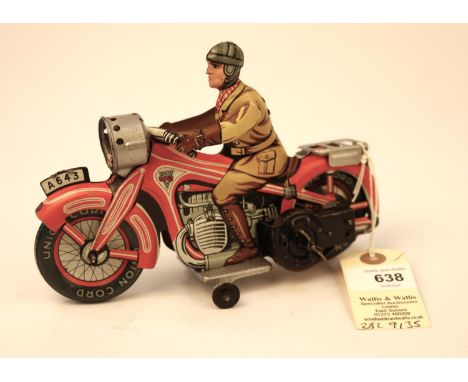 A rare Arnold A643 tinplate clockwork touring motorcycle. In red and white with litho detailing, rider in yellow/brown overal