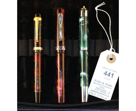 3 Visconti Fountain Pens. All of variegated design. One basically red with gold nib and gold coloured detailing. One red/grey