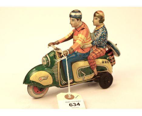 A rare Technofix friction powered Scooter Brightly litho detailed, with rider and female passenger. With a cream/orange Techn