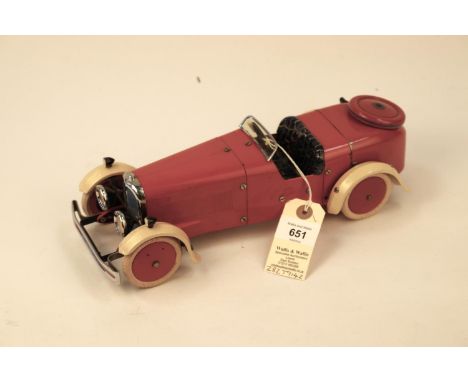 A rare 1930's No.2 Meccano Constructor Car. A round tail example in red with cream mudguards, dark blue seat, red wheels with