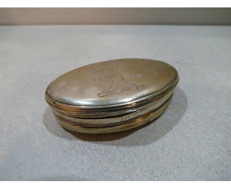A Georgian oval silver snuff box, engraved crest below the word 'through' artists initials MFS
