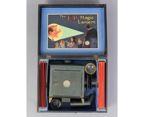 A late 19th/early 20th century “The E.P.” standard magic lantern projector set, with seventeen coloured – glass slides. 