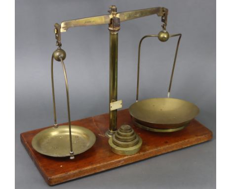 A late 19th/early 20th century large brass beam scale by W.A. Webb Ltd. of London mounted on walnut plinth base, 15¾” high, &