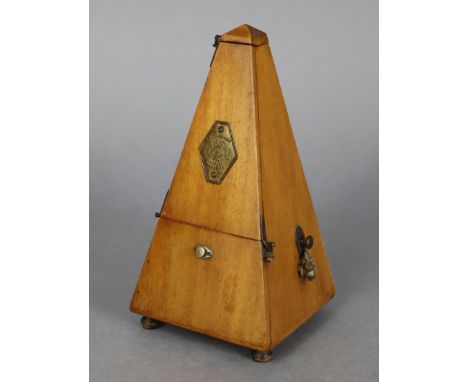 A Maezel metronome in mahogany case, 9” high.