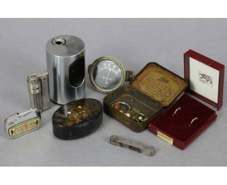 A pair of yellow-metal hoop earrings; a black papier mâché oval snuff box; a Braun silvered-metal cylindrical table lighter; 