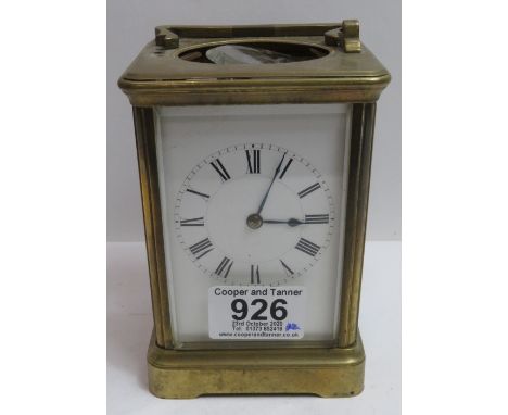 A brass cased carriage timepiece having white enamel dial, 13.5cms high with key