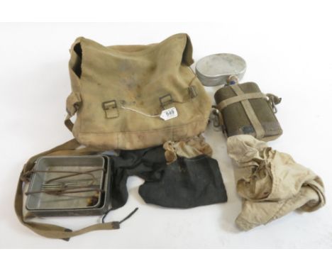 A WWII period webbing bag containing metal mess tin, enamel mug, dog tag, fork and other items relating to Lt J F Wright 1534