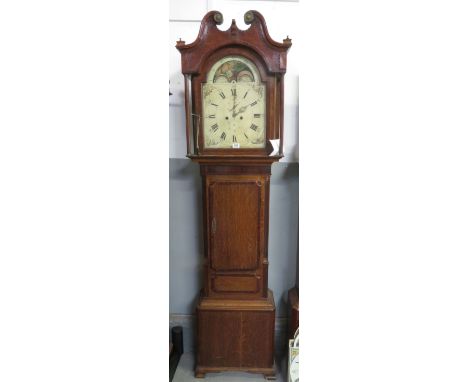 8 day longcase clock contained within an oak and crossbanded mahogany case. The partley repainted arch dial has split seconds