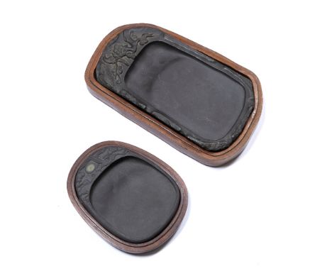 Two Duan ink stones Chinese the first of rectangular form, carved with one side with foliate motifs and birds climbing the fl