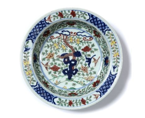 Wucai decorated basin Chinese decorated to the centre panel depicting a bird standing on a rocky outcrop surrounded by a bord