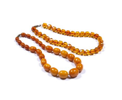 Two amber bead necklaces Chinese the first of butterscotch colour comprising single strand of graduated amber beads total len