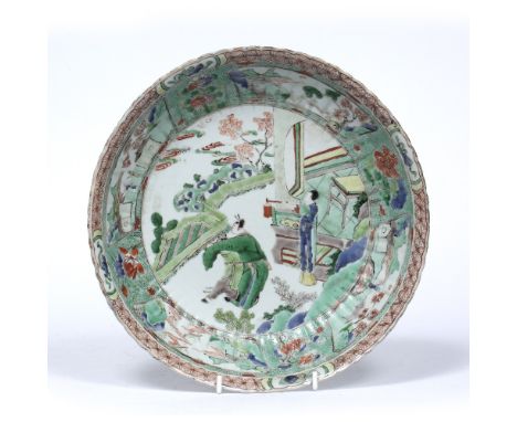 Famille verte saucer dish Chinese, Kangxi (1661-1722) decorated with three figures standing beside a home over looking a gard