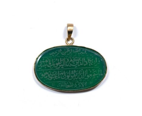Green hard stone oval panel Qajar with Islamic inscription engraved into it, mounted in a metal pendant  3.5cm across