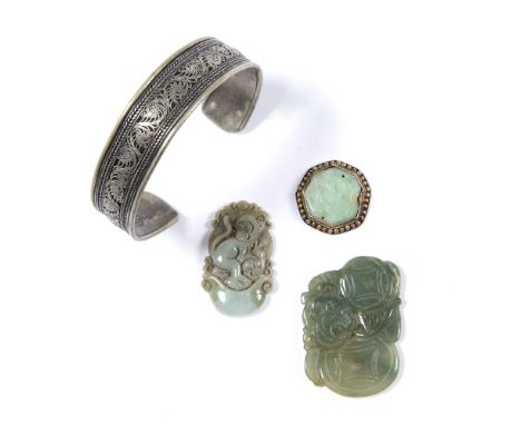 Two jade pendants Chinese one carved with bats, the other carved as a monkey  4cm across, 3cm across together with a jade mou