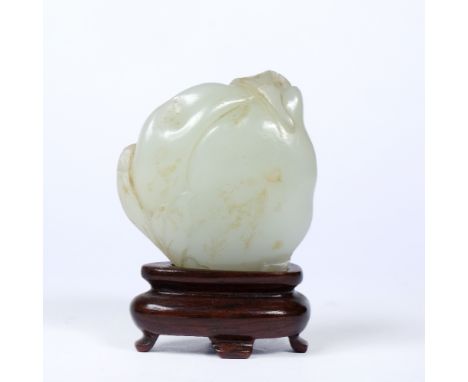 Mutton fat jade pebble Chinese, 18th Century carved as a bat and peach with wood stand 4cm x 4.5cm
