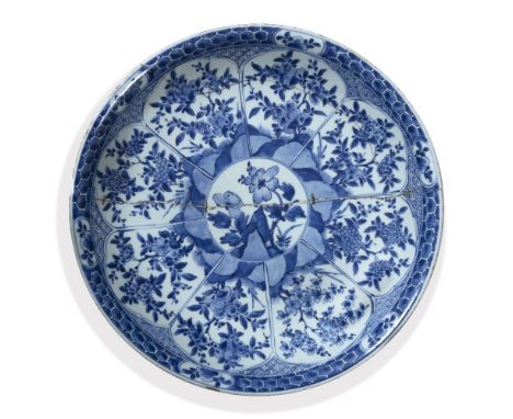 Blue and white charger Chinese, Kangxi (1662-1722) with central panel of peonies, and with further panels around the side wit