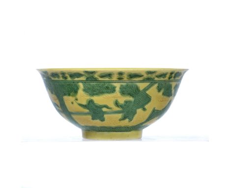 Porcelain Imperial yellow glazed bowl Chinese decorated in green enamel with children at play within a terraced garden beneat