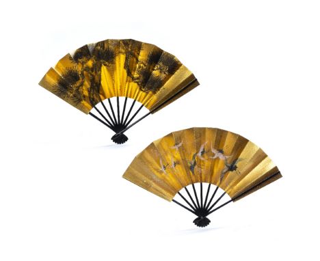 Two lacquer fans Japanese, 20th Century decorated to the centre in gold, the first depicting cranes in flight and the second 