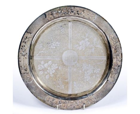 Silver circular dish Chinese, 19th/20th Century the centre decorated in four segments, each with stylized flowers,644 grams w