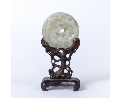 Mutton fat ritual jade bi Chinese, 18th/19th century carved in relief with a dragon encircling the diameter , reverse with an