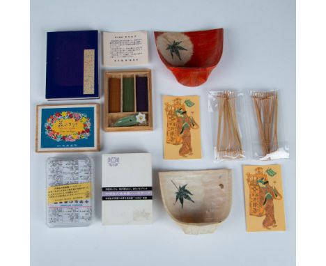 This grouping includes a small incense set, a passport stamp book or flower press book, a washable dictionary tea towel, and 