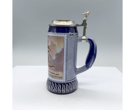 A blue glazed ceramic mug with a transfer of the winning entry in the 1990-1991 Federal Duck Stamp Competition depicting Blac