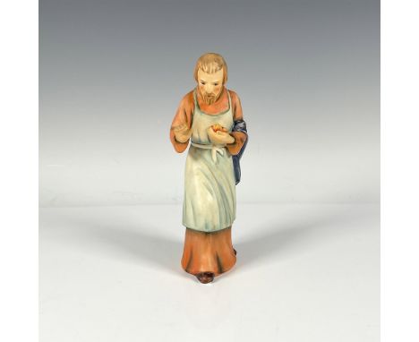 Matte finished figure in orange robe with green apron. Goebel backstamp. Hummel impressed mark. Issued: c. 1951Dimensions: 2.