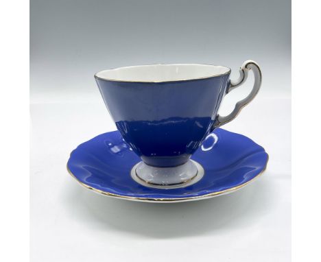 Ridged design colored in vibrant blue with gilt rim, base and accent on handle. Cup measures 3"H x 3.5" dia. and saucer 1"H x