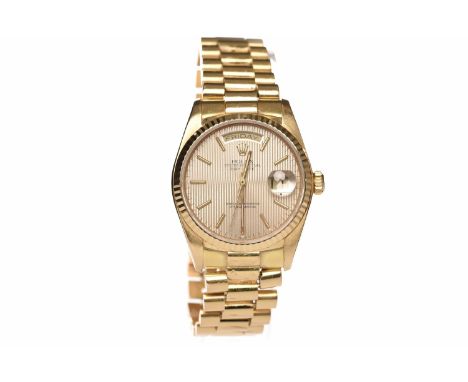 GENTLEMAN'S ROLEX OYSTER PERPETUAL DAY-DATE EIGHTEEN CARAT GOLD AUTOMATIC WRIST WATCHthe round gold coloured dial with linear