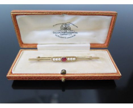 A Ruby and Seed Pearl Bar Brooch in 15ct yellow gold setting, by The Goldsmiths & Silversmiths Co. 3.2 g