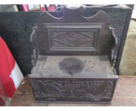 A Victorian Carved Oak Wall Shelf with cabinet and carved with naive carving of birds, 54 (h) x 48 (w) cm