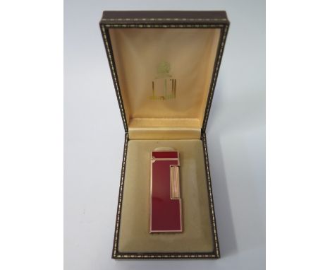 A Dunhill Gold Plated and Red Enamel Lighter in original case 110139