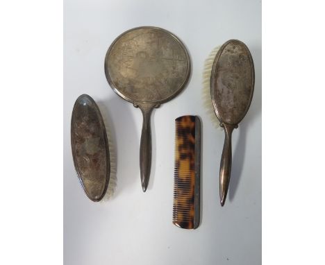 An Elizabeth II Silver Backed Three Part Mirror and Brush Set decorated with swans and matched comb