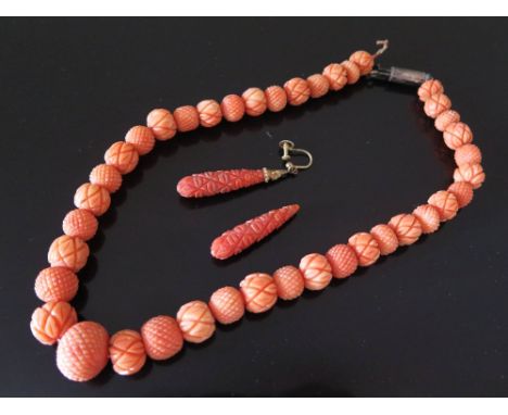 A Victorian Carved Coral Necklace and pair of matching earrings A/F, 70.6 g. The largest bead is c. 15.5 mm x 13 mm. It is 37