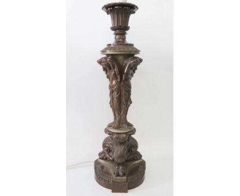 A Finely Sculpted Bronze Lamp raised on the backs of three maidens and resting on lion paw feet, 52 cm