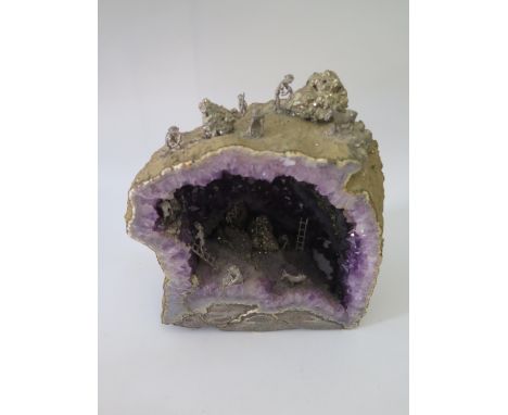 An Amethyst Geode with miniature mining scene, 25 cm high