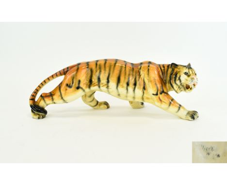 Ceramic Tiger Figure Prowling tiger with open mouth and exposed teeth, faded factory mark to underside. approx dimensions, 4 