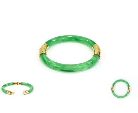 A Mid 20th Century Jadeite Bangle with Unmarked Gold Bands. Nice Condition - Please See Photo. Diameter 3 Inches. 