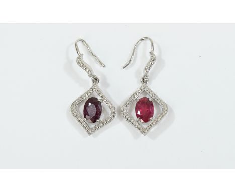 Pair of Ruby Pendant Earrings, each earring comprising an oval cut solitaire ruby, of over 1ct, set within a millgrain, twist